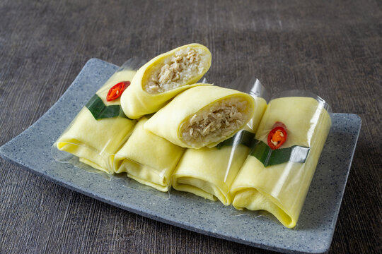 Traditional Javanese semar mendem, savory chicken stuffed sticky rice wrapped in thin egg omelet, Authentic Indonesian snack