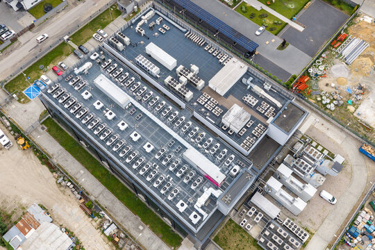 Aerial view of the Datacenter T-Mobile building featuring rows of cooling units and industrial equipment on the rooftop Warszawa, Wojewodztwo mazowieckie, Poland.