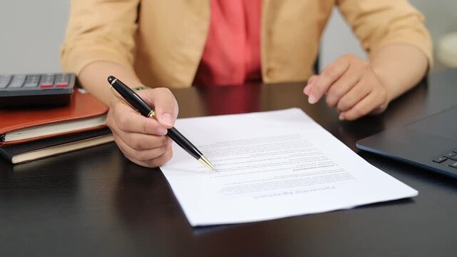 Woman, hands and checking documents for business contract, survey or company policy in office. Female person, employee or reading with pen or paperwork for application or insurance in workplace