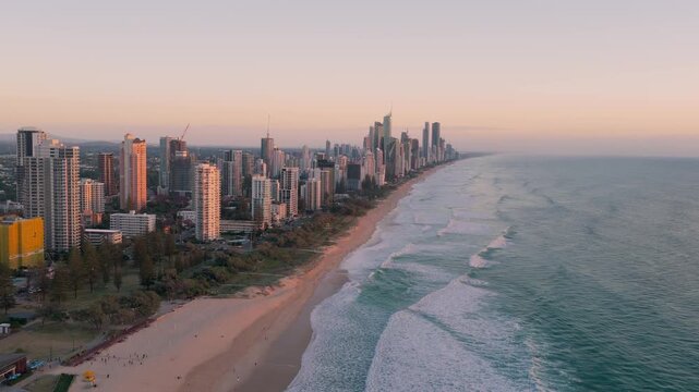 Aerial View Of Surfers Paradise Skyline With High-rise Buildings And Sandy Coastline At Sunrise In Gold Coast, QLD, Australia. - pullback shot