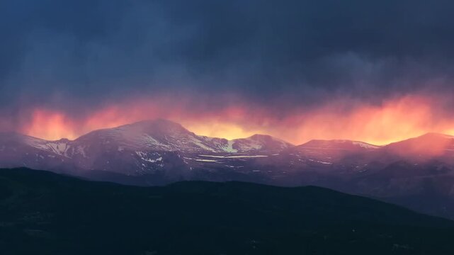 Sunset golden hour vibrant orange dark thunderstorm rain cloud fire orange sky Mount Blue Sky aerial drone Colorado Rocky Mountains Spring landscape Mount Evans Wilderness front range peaks circle