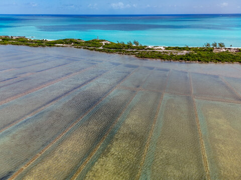Aerial view of the historic Salt trading post and salt pans along the turquoise coastline of Exuma, Exuma, The Bahamas.
