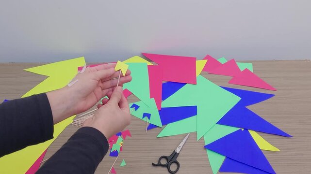 Preparation for Festa Junina - Sticking mini flags onto toothpicks with tape