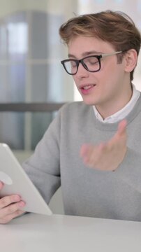 Young Man making Video Chaton Tablet in Modern Office, Vertical Video