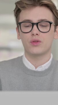 Close up of Young Man Talking on Video Chaton Laptop, Vertical Video