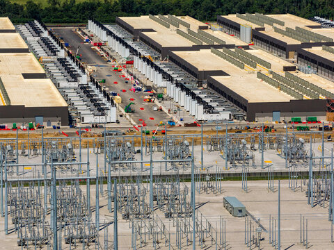 Aerial view of the data ai center buildings and power station, energy source in the foreground
