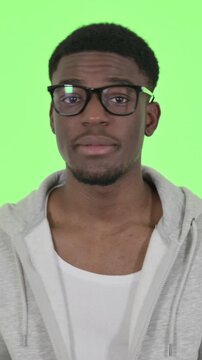 African Man Talking on Online Video Chat on Green Background, Vertical Video