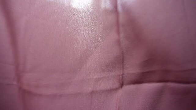 Pink silk fabric background footage in slow motion