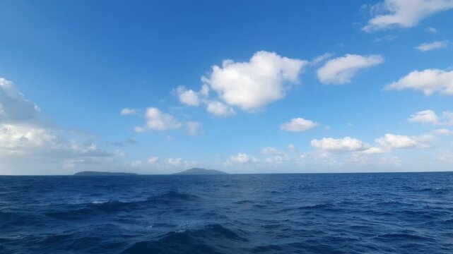 various shapes of clouds in the sky above the choppy sea