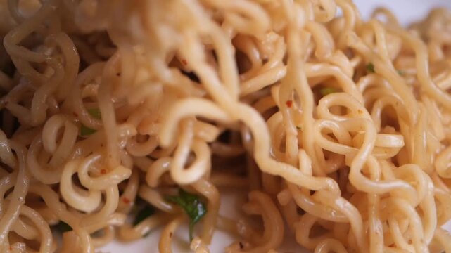 Cooking instant noodles with flavor packet in kitchen