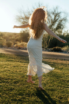 girl twirling in a desert park