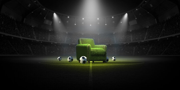 Green grass armchair and balls on a soccer field in a stadium at night