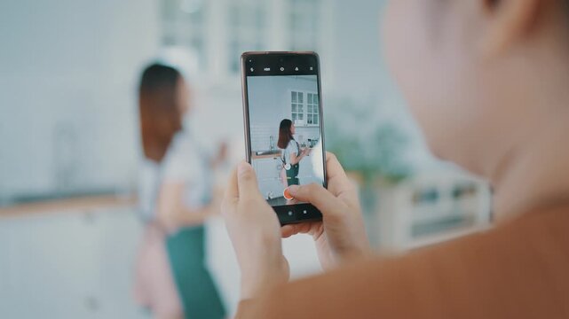 Young asian womans shooting together dancing in kitchen at house when making video for social media, stories trendy dance at home make online content