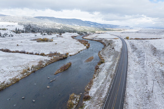 Aerial photography of the natural landscape driving through the snowy forests of Montana, USA