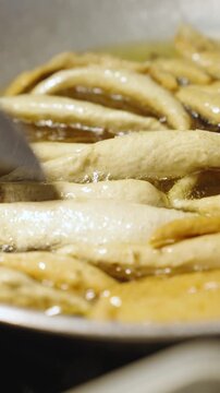 Street Food Vendor Frying Tempura in Hot Oil at Outdoor Market