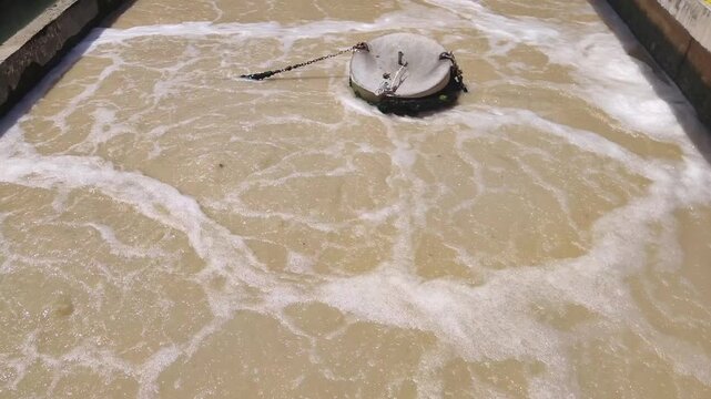 Industrial Wastewater Treatment Process with Bubbling Brown Sewage Water.