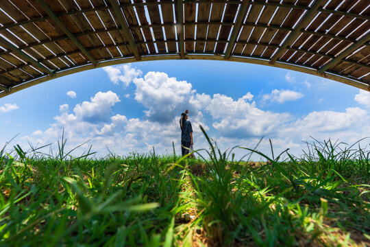 Asian female tourist stands admiring the view of Nong Han Lake at Khu Sut Park in Sakon Nakhon Province, Thailand
