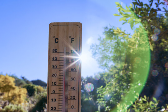 Outdoor thermometer displaying high mercury levels, depicting extreme summer heat, global warming, and hot weather conditions