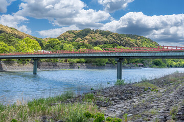 Fototapeta premium Uji Bridge and Uji River Under Blue Sky in Kyoto, Japan