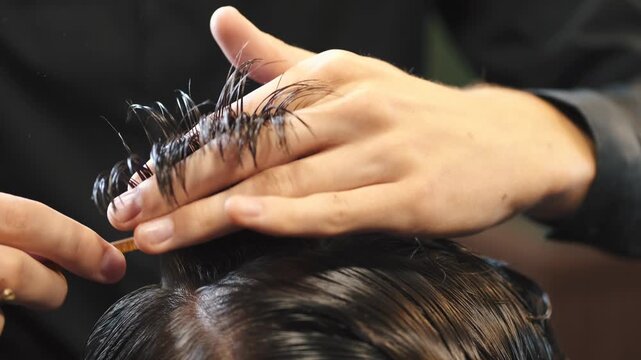 Close up of scissor work during haircut، Barber using comb and scissors together، Salon expert cutting dry hair for precision، Hair expert cutting a modern crop، Hair expert cutting a casual male