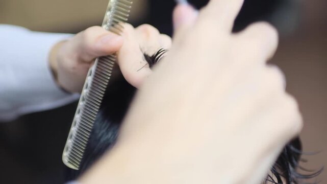 Close up of scissor work during haircut، Barber using comb and scissors together، Salon expert cutting dry hair for precision، Hair expert cutting a modern crop، Hair expert cutting a casual male