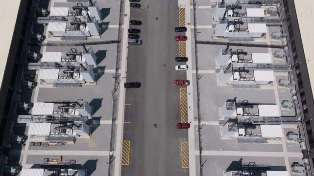 Aerial view of rows of industrial power generation units and cooling systems at a data center facility 