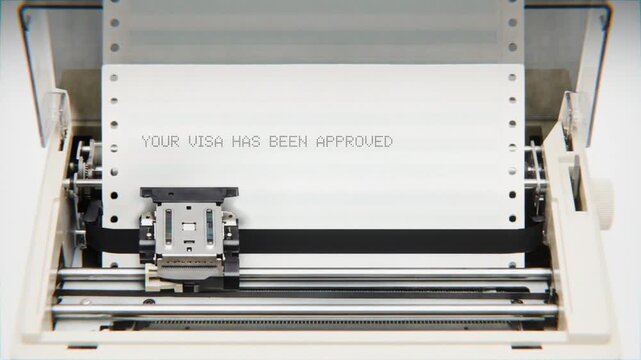 Old Dot Matrix Printer Printing YOUR VISA HAS BEEN APPROVED Text on continuous white paper Close Up view.