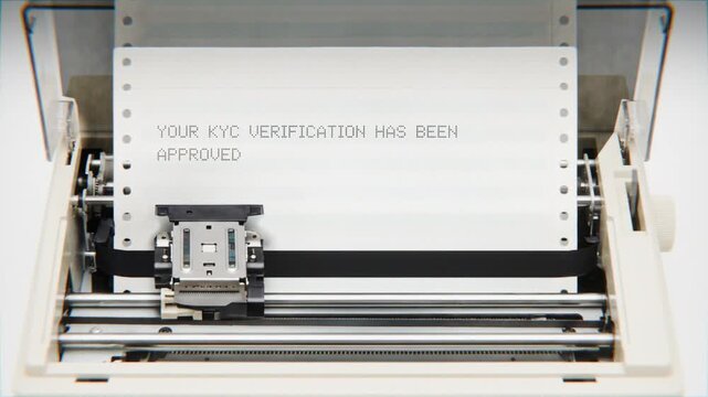 Old Dot Matrix Printer Printing YOUR KYC VERIFICATION HAS BEEN APPROVED Text on continuous white paper Close Up view.