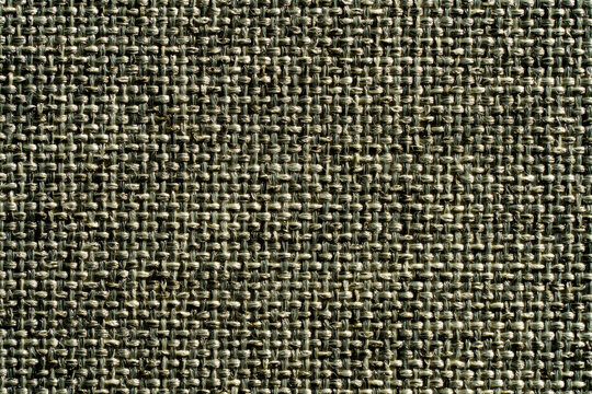 Detailed macro shot of coarse woven fabric texture in neutral tones. Perfect for upholstery interior design and textile industry backgrounds