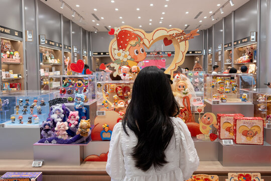 PENANG, MALAYSIA - FEB 09, 2026: Rear view of a lady standing in front of Pop Mart Twinkle Twinkle themed collectible toy display inside retail store.