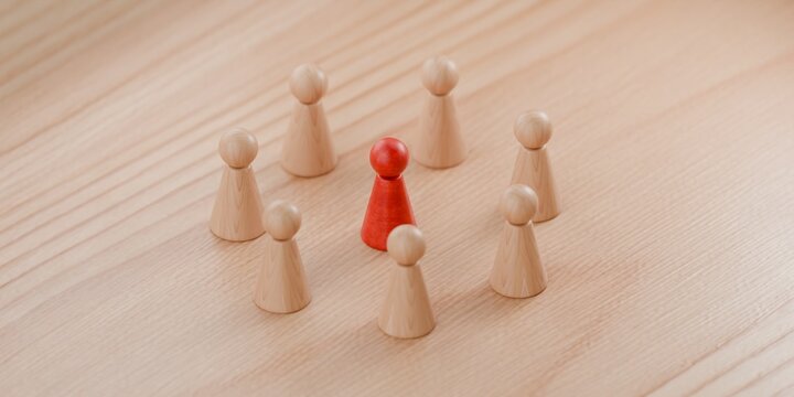 3d wooden pawn figurines with one highlighted in red, criticism, social state of mind