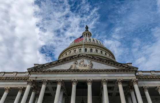 Capitol famous architecture in Washington DC skyline. Patriotic exterior landmark in Washington DC cloudy sky. Washington law Congress Senate democracy Washington. Historic national icon.