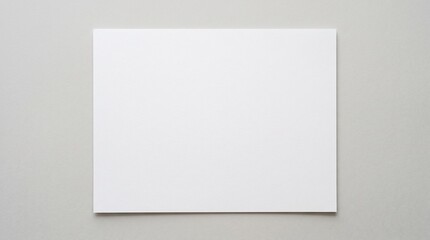 Fototapeta premium Clean blank white paper mockup presented in a minimalist workspace setting. Features a top-down view of an empty sheet on a wooden desk notebook, and coffee cup, alongside an isolated b