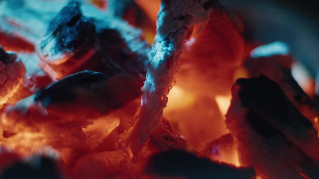 Sausages on the BBQ grilled on the natural coal fire at night. Close up view with shallow DOF