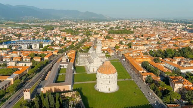 Pisa, Italy. The Leaning Tower and Pisa Cathedral in Piazza dei Miracoli, Drone footage over manicured lawns and terracotta rooftops at golden hour. Drone footage, Point of interest