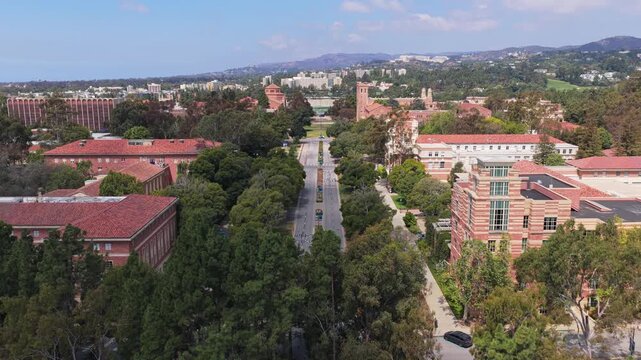 University of California Los Angeles campus with Westwood, Bel Air, and Santa Monica Mountains in background, showing academic buildings and main thoroughfare