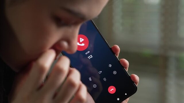 Woman calling emergency number 112 for crisis situation