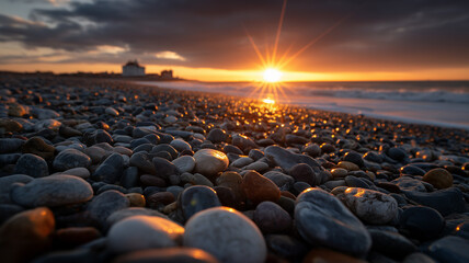 Obraz premium A sunset beach scene from a low perspective, focusing on a wide array of smooth, wet pebbles in the foreground. Ai generated