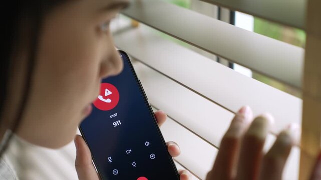 Woman calling emergency number 911 for crisis situation