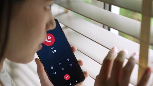 Woman calling emergency number 112 for crisis situation