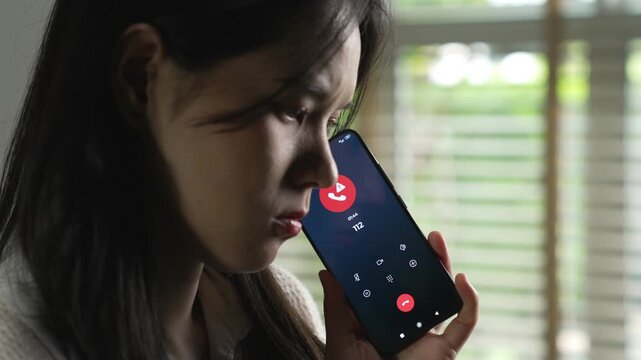 Woman calling emergency number 112 for crisis situation