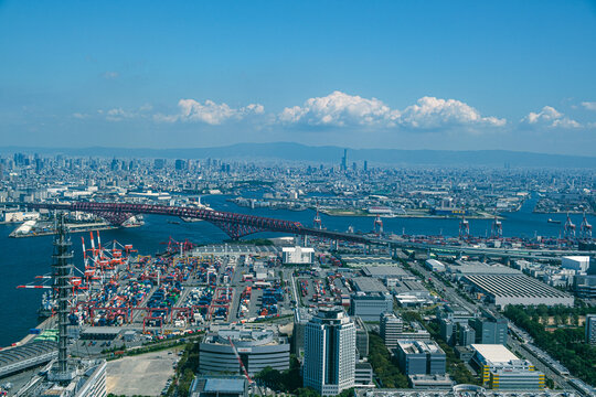 Aerial View of Osaka Port Container Terminal with Red Arch Bridge and City Skyline