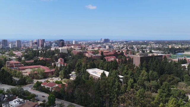 Westwood Los Angeles, UCLA campus, Beverly Hills high rise buildings with Bel Air luxury real estate and Pacific Ocean on horizon under a clear blue sky