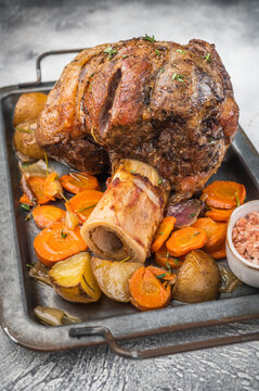 Italian veal osso buco shank braised with vegetables marrow bone and herbs on light stone background