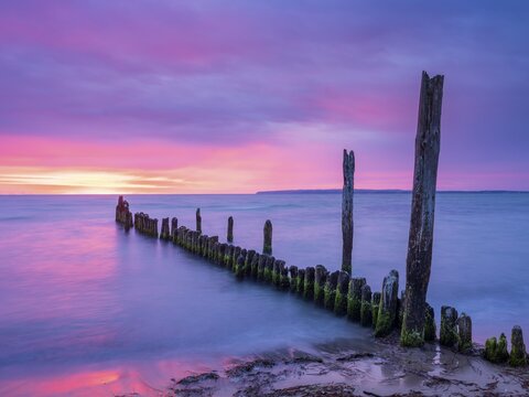 Sunrise on the Baltic Sea beach with old grouse at the Baltic Sea resort of Breege-Juliusruh, Wittow Peninsula, R&uuml;gen Island, Mecklenburg-Western Pomerania, Germany