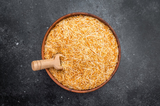 Raw kataifi pastry strands used for Middle Eastern and Mediterranean desserts. Thin shredded phyllo texture with copy space