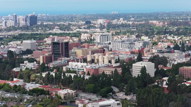High altitude flight over UCLA Health Campus, with Westwood, Century City and Pacific Ocean visible in far background of the cityscape