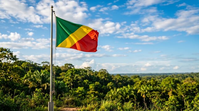 Republic of the Congo flag waving on pole over lush tropical rainforest landscape with sky