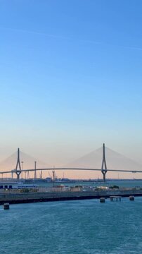 Beautiful panoramic view of the constitution of 1812 bridge, known as la pepa bridge, in cadiz, spain, with seagulls gracefully flying over the tranquil blue waters of the bay
