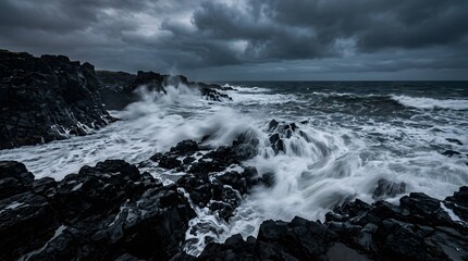 Fototapeta premium Stormy sea waves crashing on black volcanic rocks, long exposure, dramatic sky, moody tones, no people 